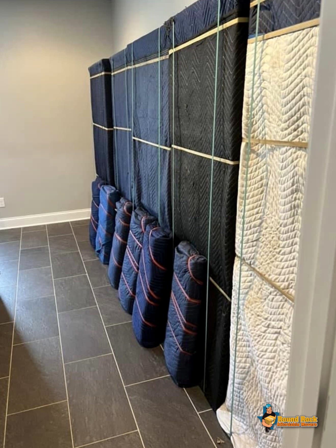 Furniture wrapped and secured in a hallway, ready to load, by Round Rock Affordable Movers