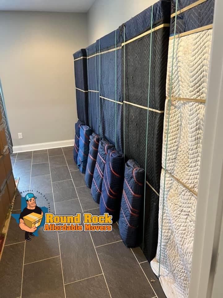 Furniture fully wrapped in moving blankets and secured, ready to load, by Round Rock Affordable Movers